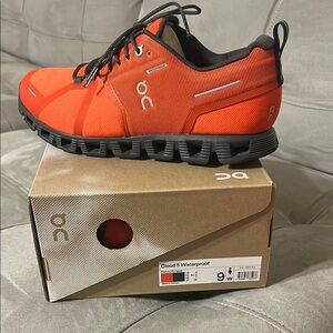 On Running Orange and Gray Athletic Shoes with Cloud Technology